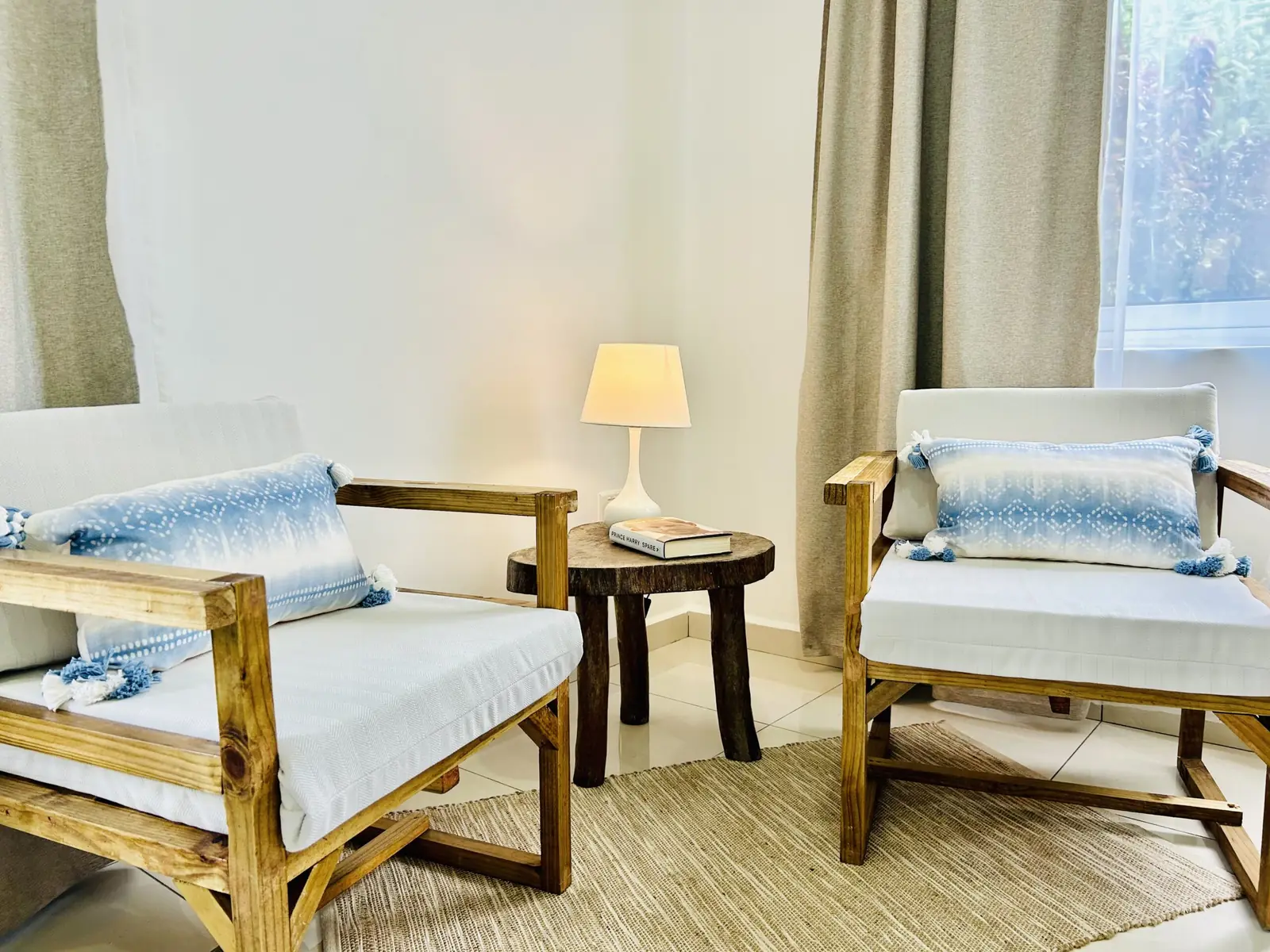 Two armchairs and a reading lamp in a calm, light-filled room